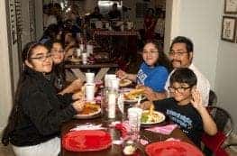 A WARM Place family enjoys a potluck dinner.