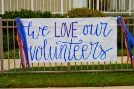 a big poster that says "We Love Our Volunteers"