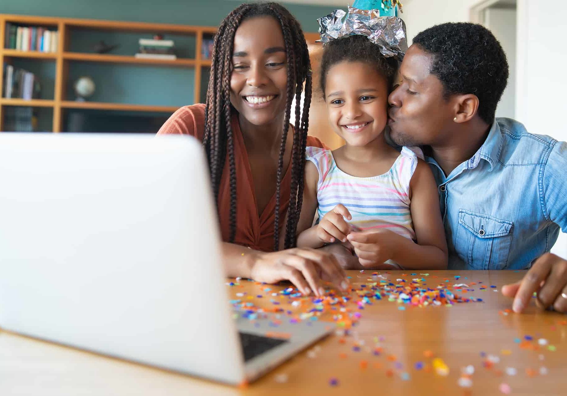 Family celebrating birthday online at home.