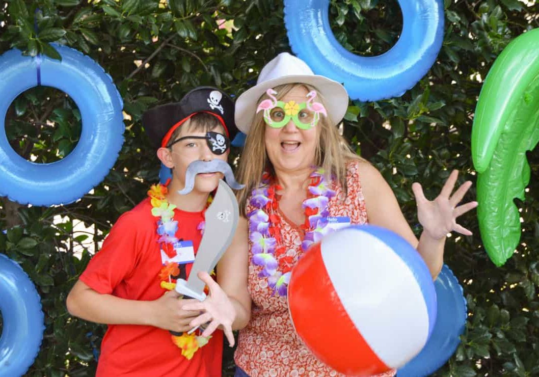 img-family-night-1@2x A mother and son pose with silly props