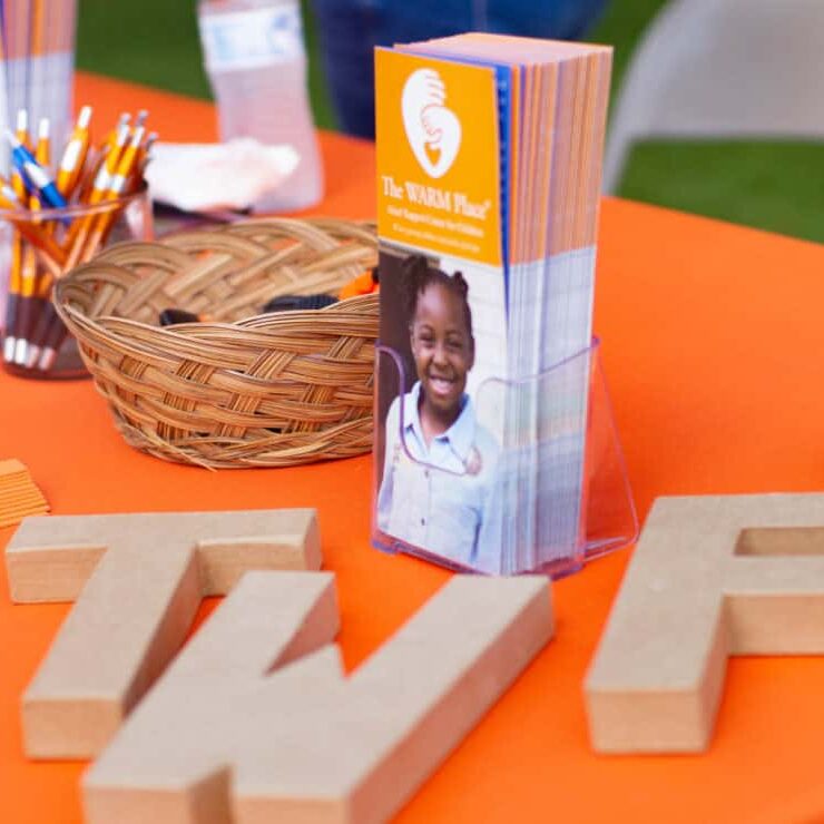 Printed materials for The WARM Place displayed on a table