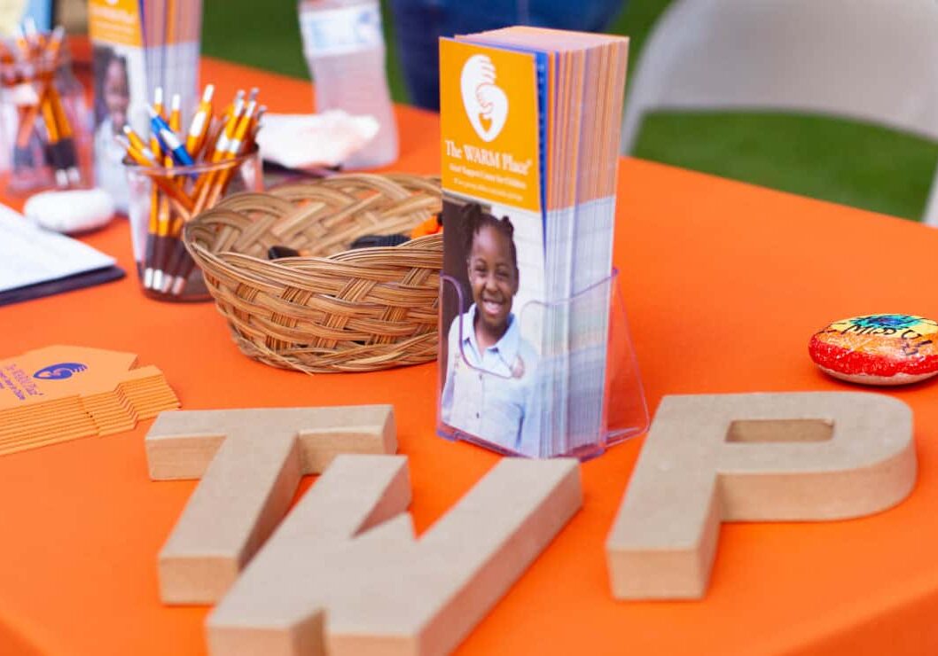 Printed materials for The WARM Place displayed on a table