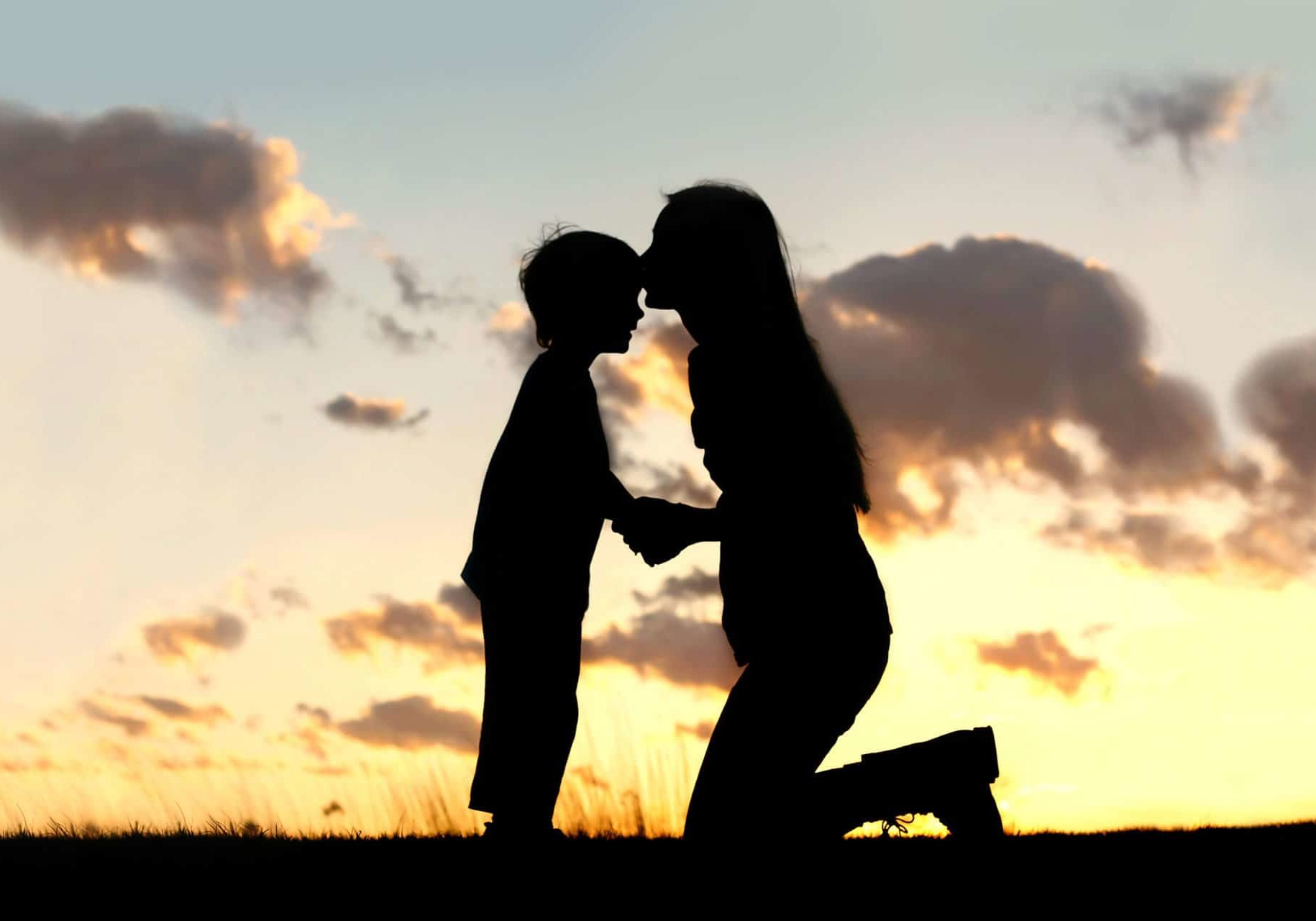 Silhouette,Of,A,Young,Mother,Lovingly,Kissing,Her,Little,Child