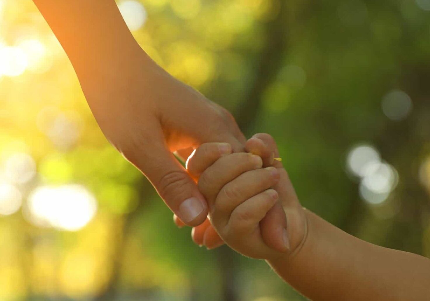 Daughter,Holding,Mother's,Hand,Outdoors,,Closeup.,Happy,Family