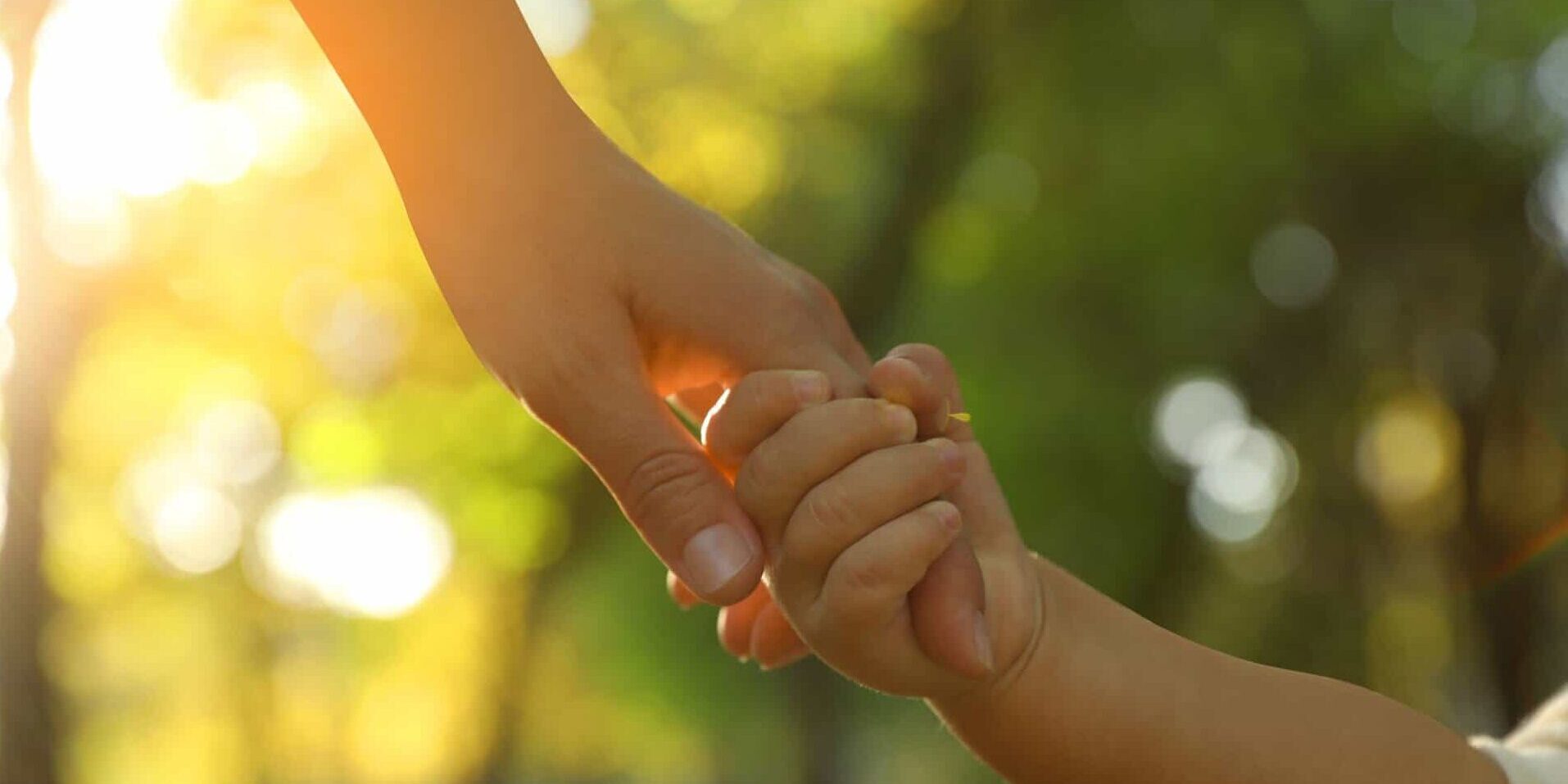 Daughter,Holding,Mother's,Hand,Outdoors,,Closeup.,Happy,Family